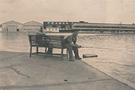 Two men fishing across from France Field