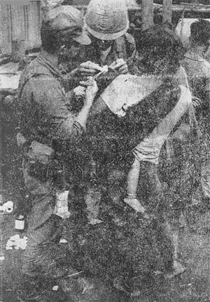 2Lt. Hugh Harris helps Montagnard baby