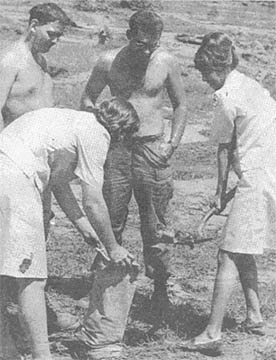 Red Cross workers help GIs fill sandbags