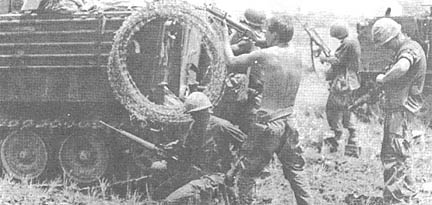 PFC Donald Stanfill fires, PFC Charles Cooper (kneeling) reloads