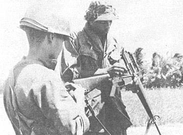 PFC Dennis Staples instructs on cleaning weapon