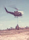 Huey carrying damaged Light Observation Helicopter