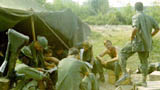 1st Platoon preparing to go to Chu Chi for stand down.  Shaves? standing, right, 'Pappy' in front of him, Edwards behind the 60